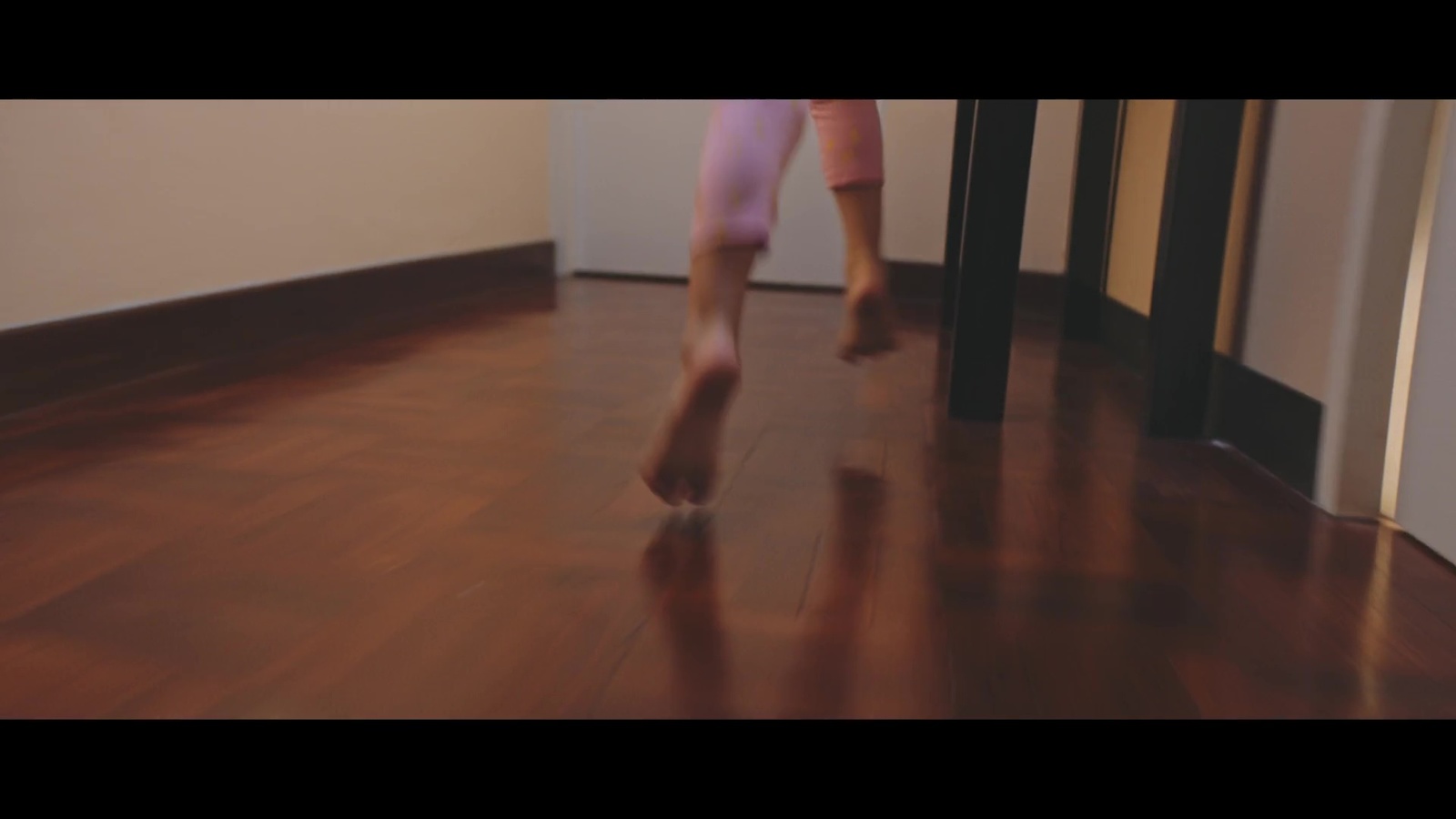 a person walking on a hard wood floor