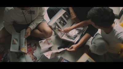 a group of people sitting on the floor looking at a book