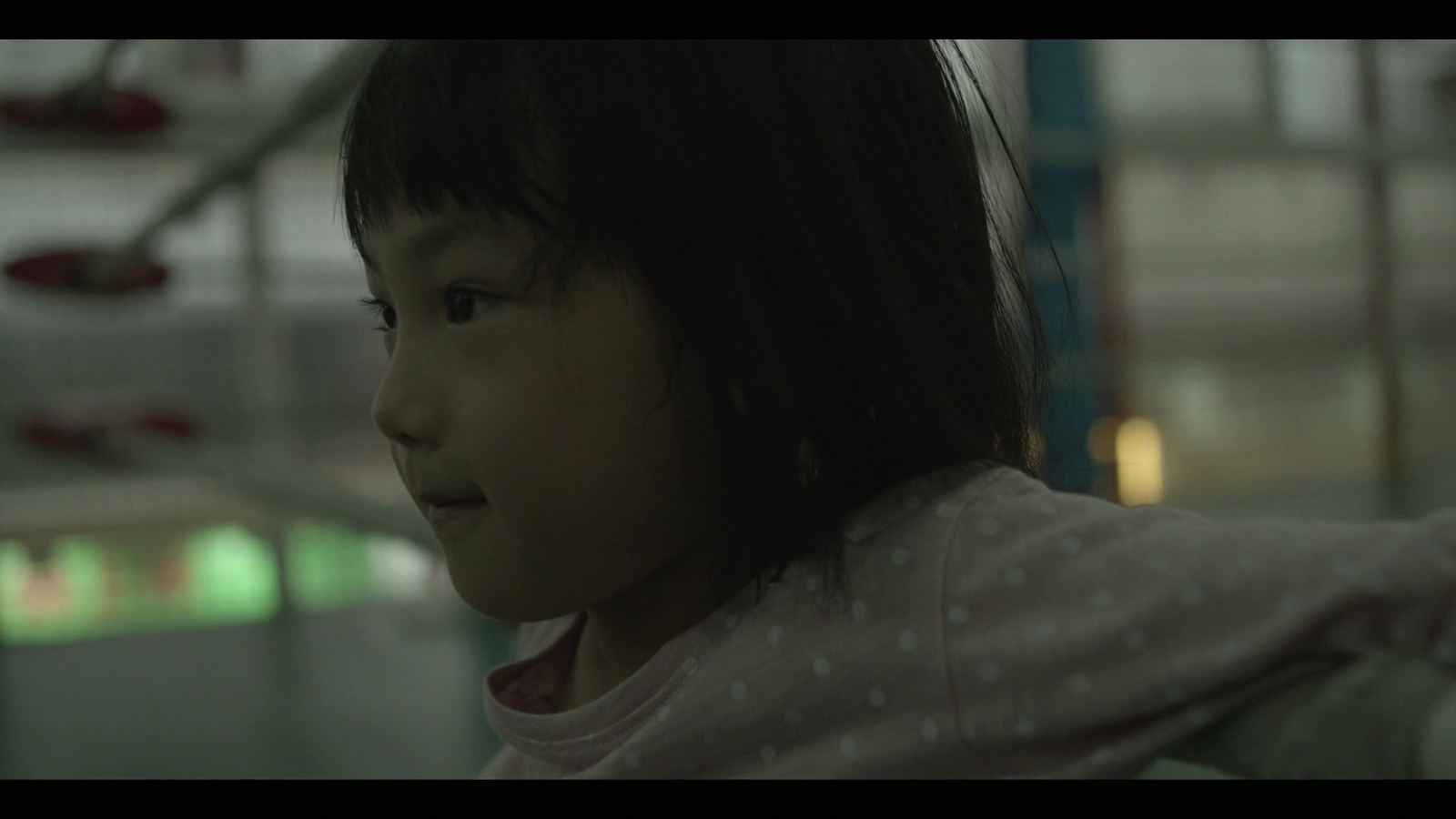 a little girl standing in front of a building