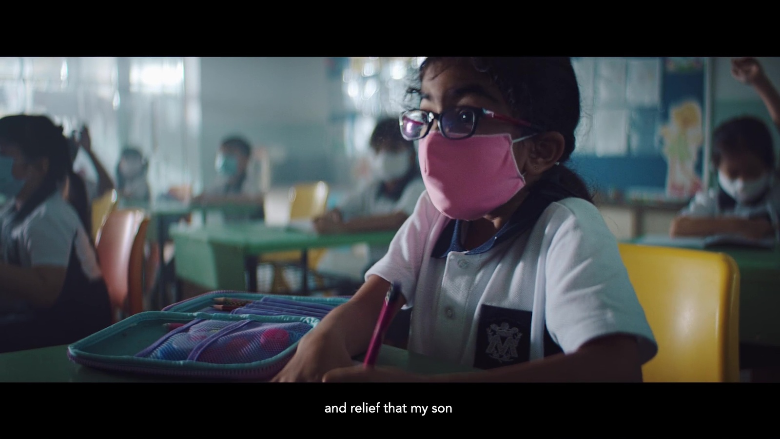 a young girl wearing a pink mask and glasses