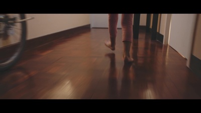 a blurry photo of a person walking on a wooden floor