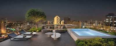 a rooftop with a swimming pool and lounge chairs