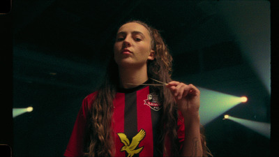 a woman with long hair standing in a dark room