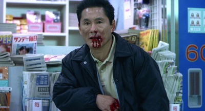 a man with blood on his face standing in a store