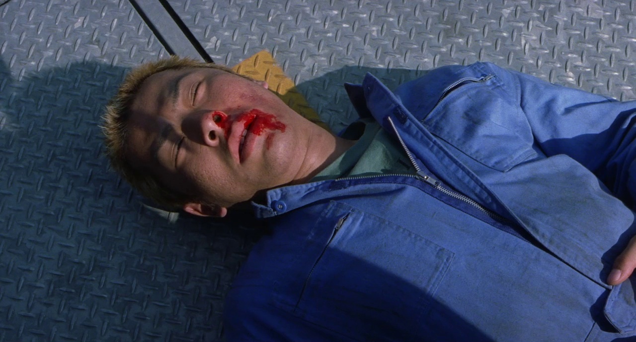 a man with blood on his face laying on the ground