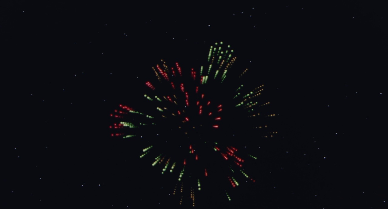 a colorful fireworks is lit up in the night sky