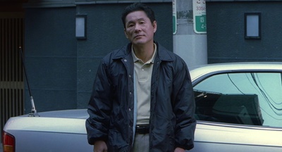 a man standing in front of a white car