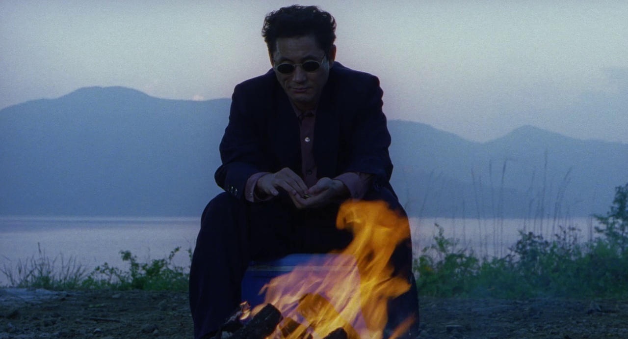 a man sitting in front of a fire