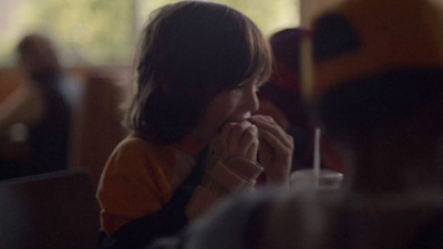 a woman sitting at a table in a restaurant