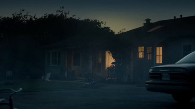 a car parked in front of a house at night