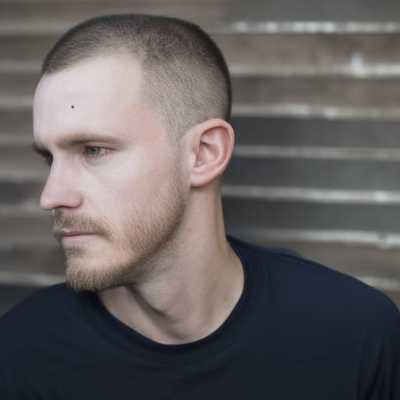 a close up of a person with a shaved head