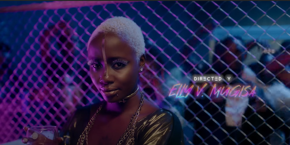 a woman with white hair standing in front of a fence