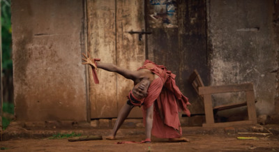 a man in a red robe is doing a handstand