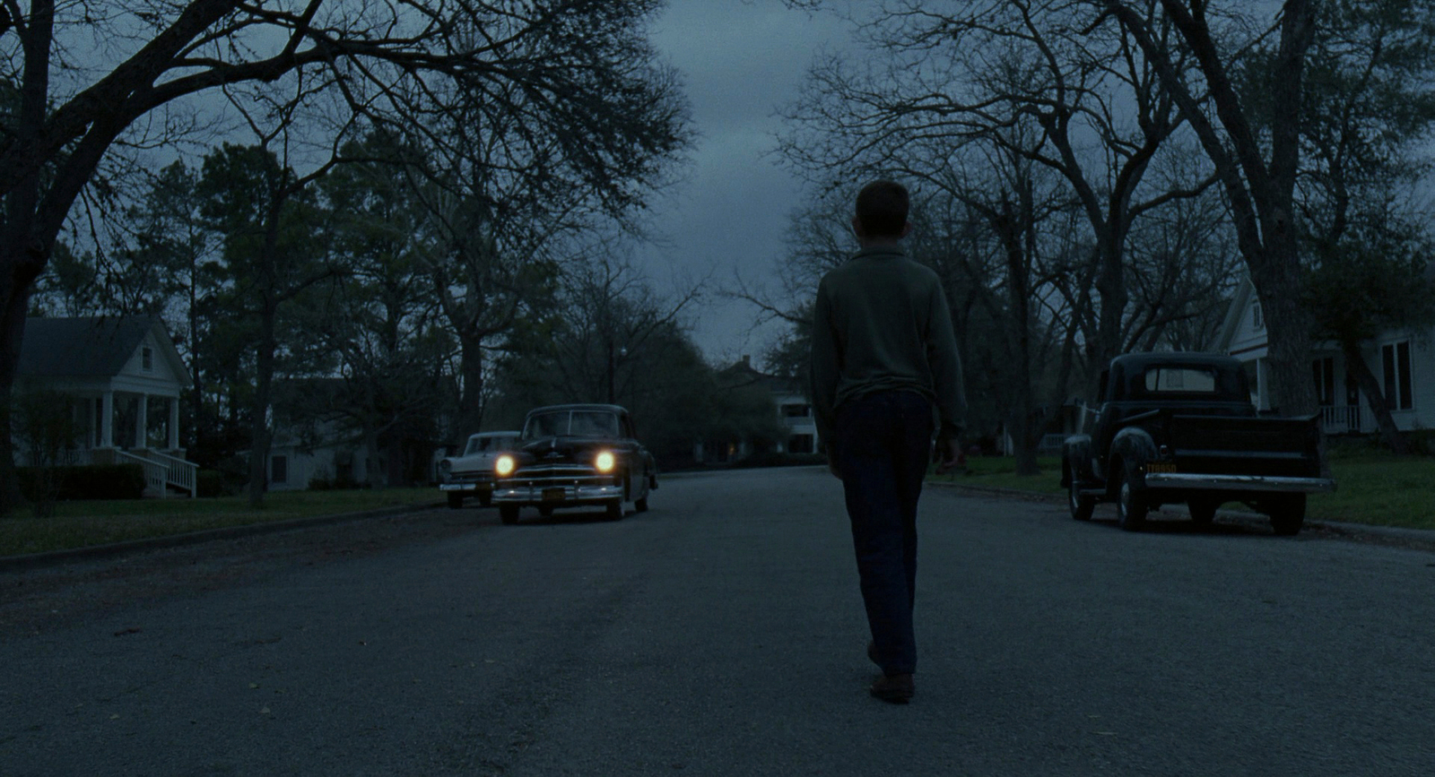 a person walking down a street at night