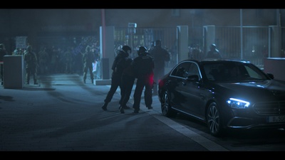 a car parked on the side of a street at night