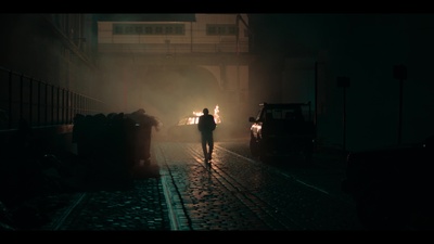 a person walking down a street in the dark