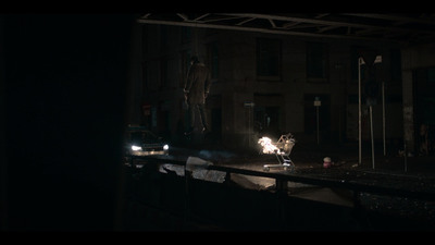 a car driving down a street at night