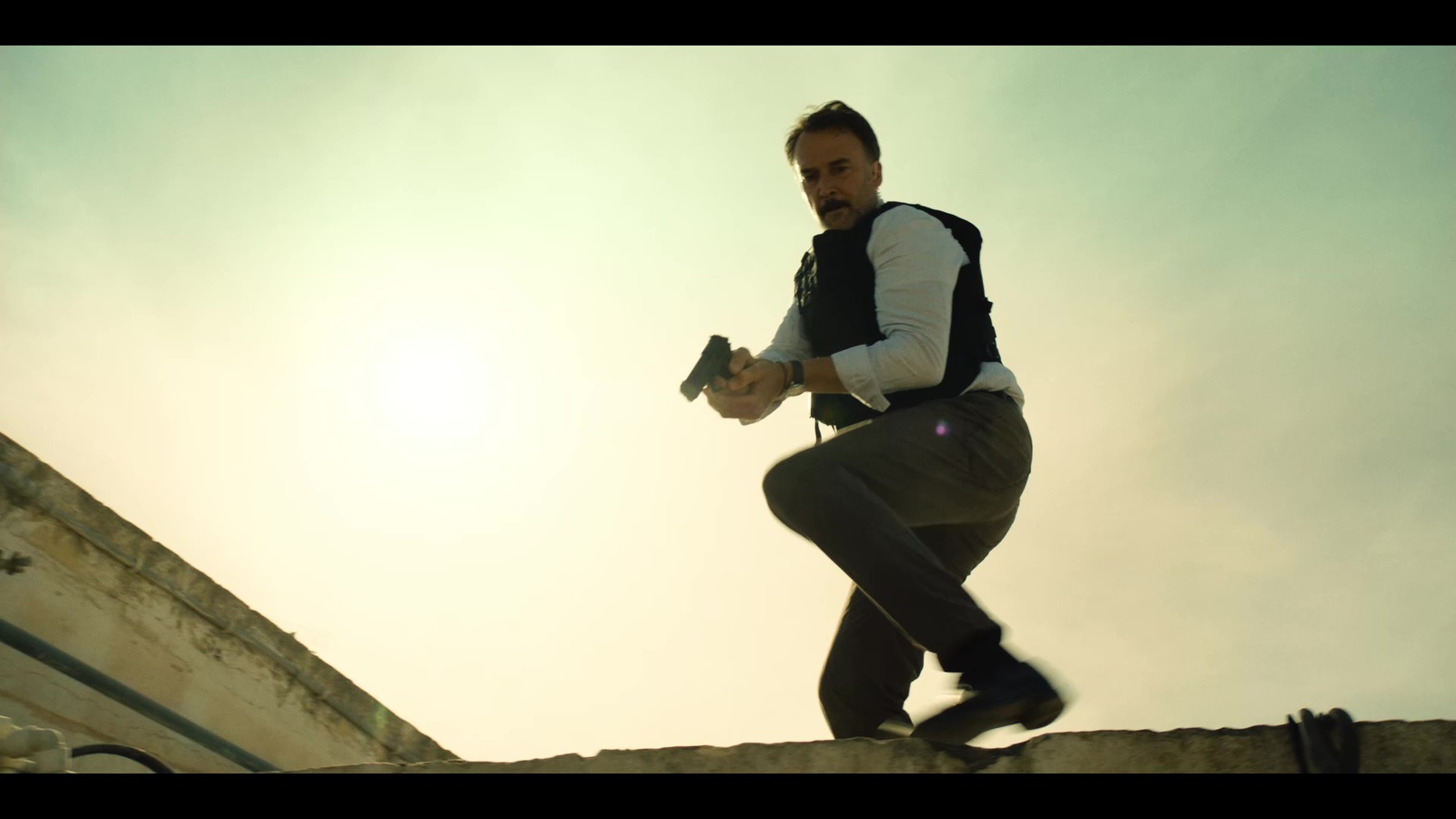 a man riding a skateboard down the side of a stone wall