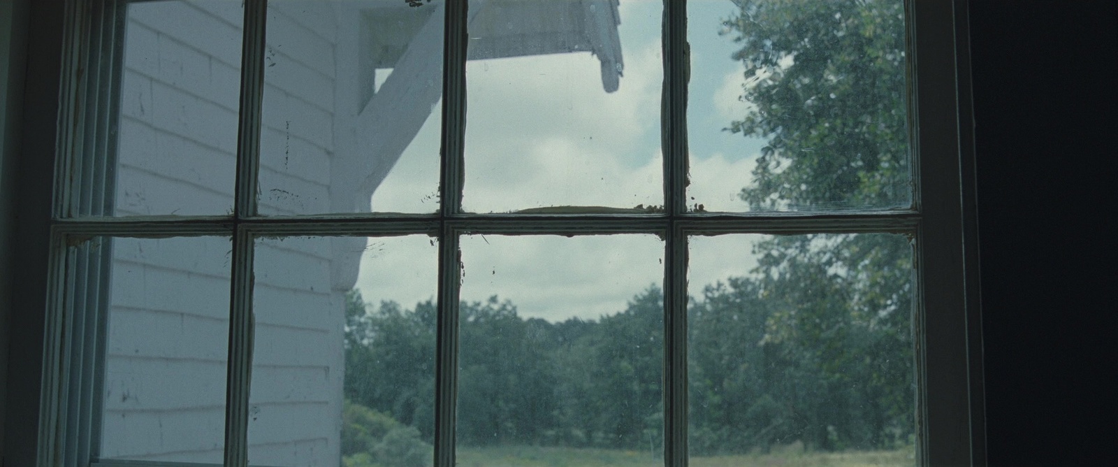 a window with a view of a house through it