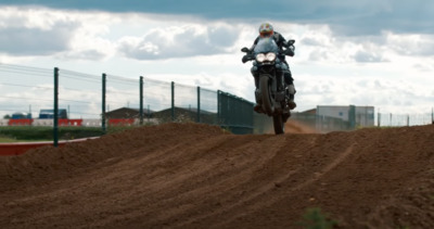 a person riding a motorcycle on a dirt road