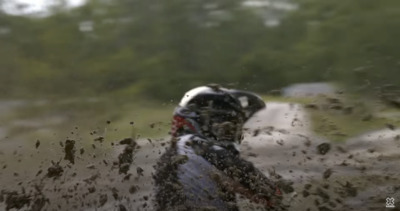 a person riding a dirt bike through a puddle of water