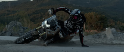 a man riding a dirt bike on top of a dirt field