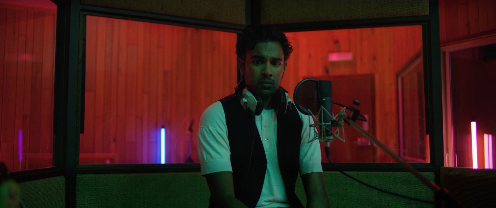 a man sitting in front of a microphone