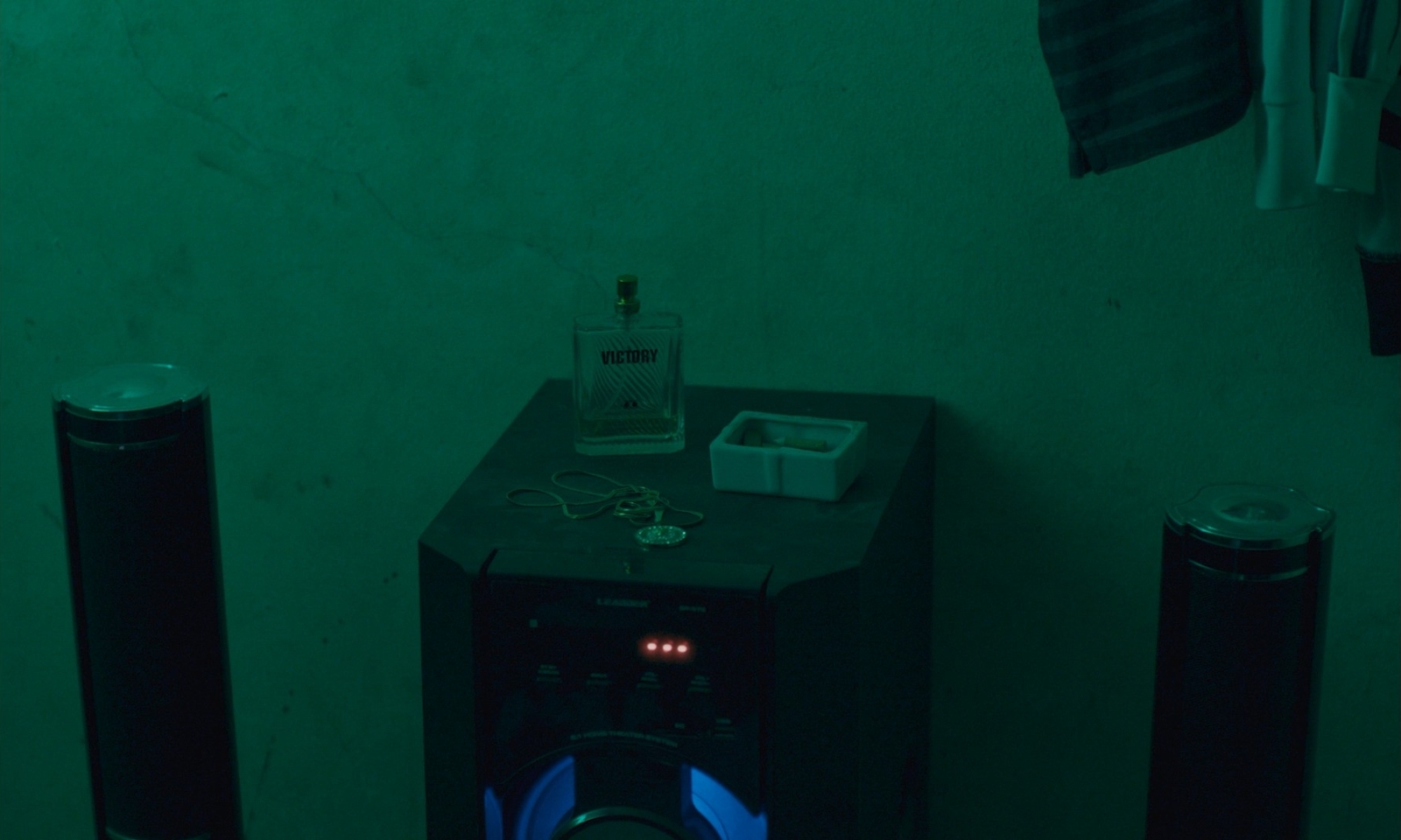 a room with two speakers and a bottle of alcohol