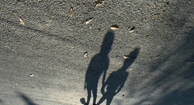 a shadow of a person standing in the sand