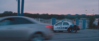 a police car parked next to a police officer