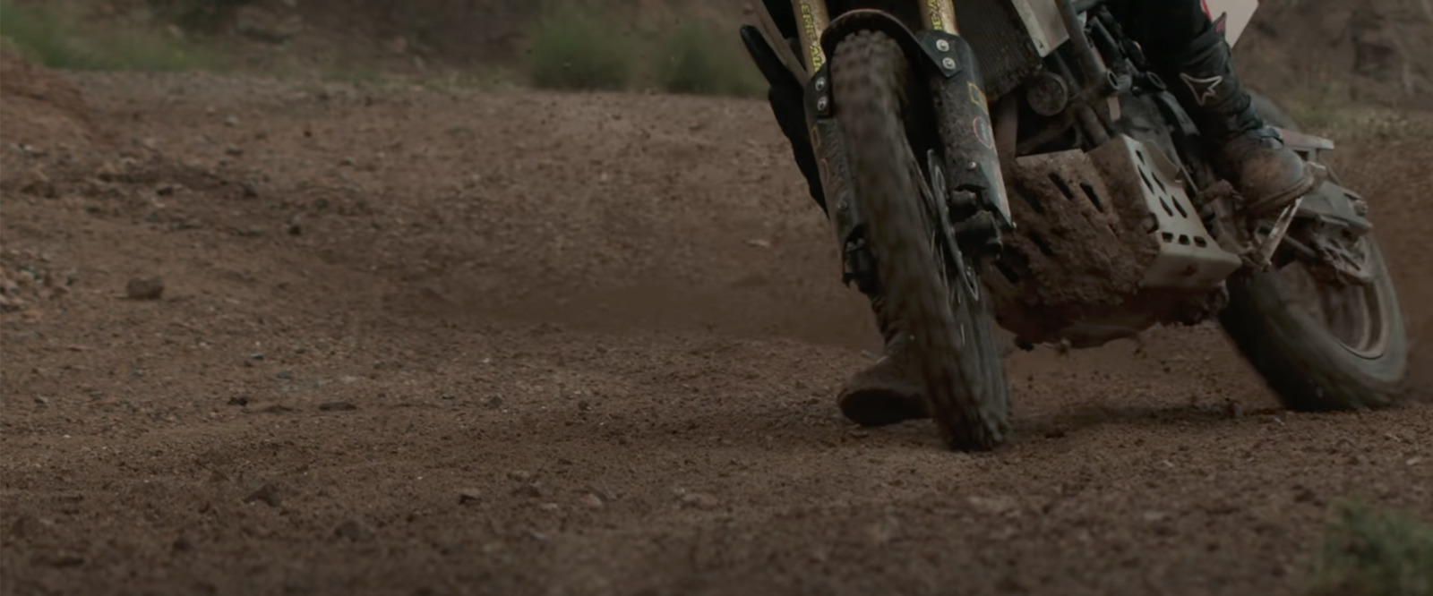 a person riding a dirt bike on a dirt road