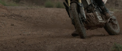 a person riding a dirt bike on a dirt road