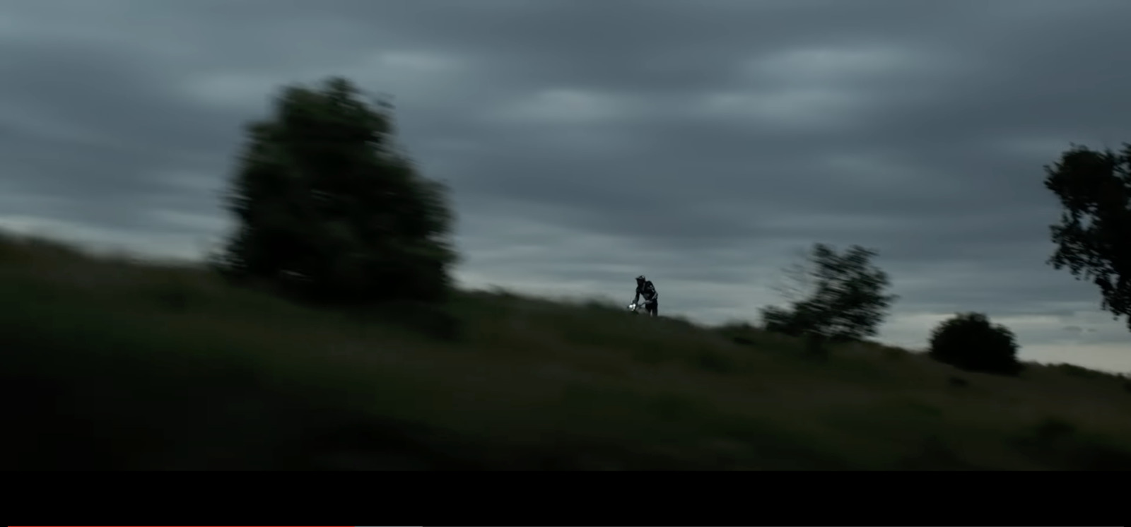 a blurry photo of a person standing on a hill