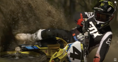 a man riding a dirt bike on top of a dirt field