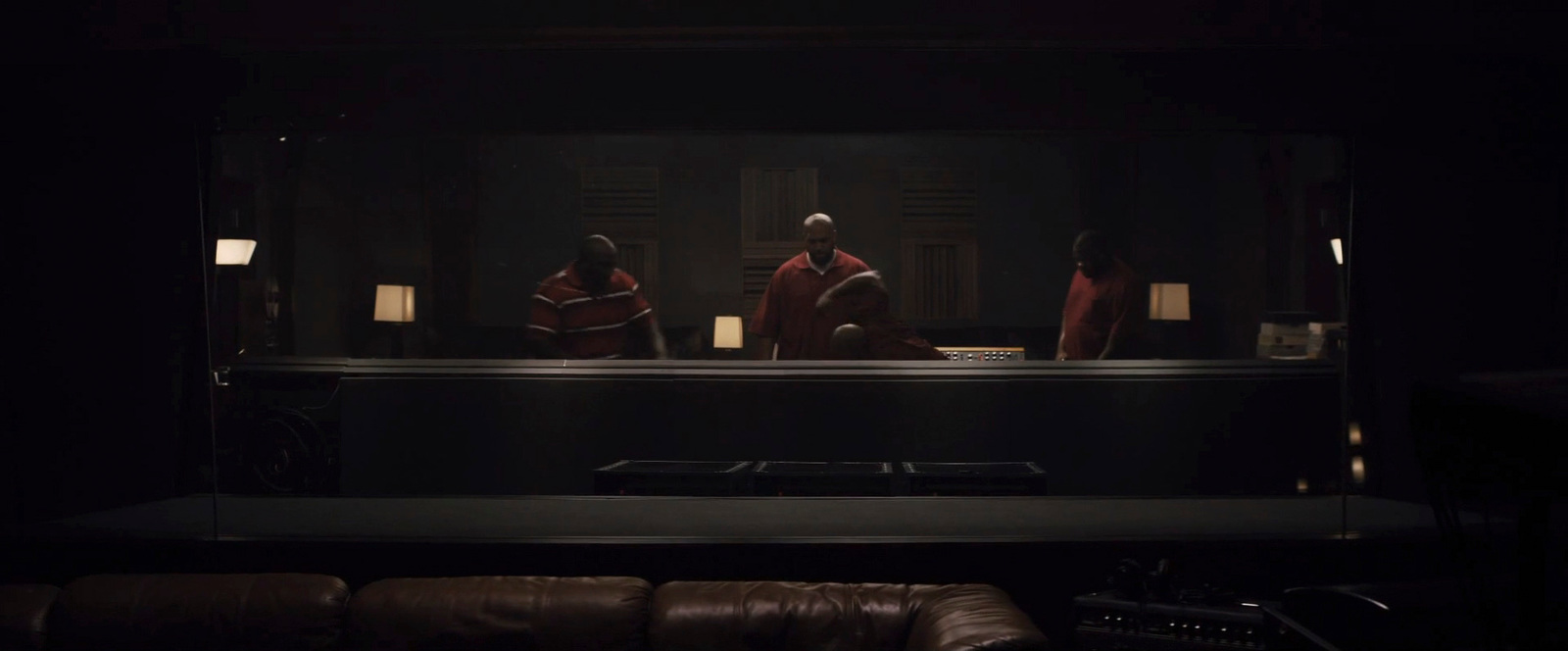 a group of people sitting at a table in a dark room