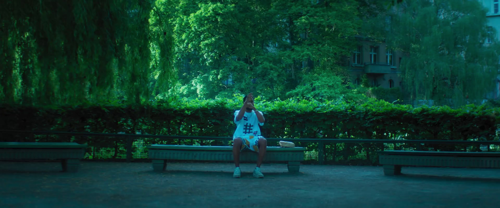 a woman sitting on a bench in a park