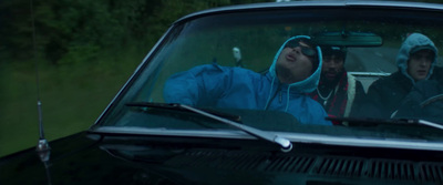 two people sitting in a car in the rain