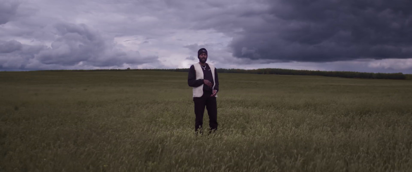 a man standing in a field of tall grass