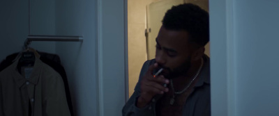 a man smoking a cigarette in a room