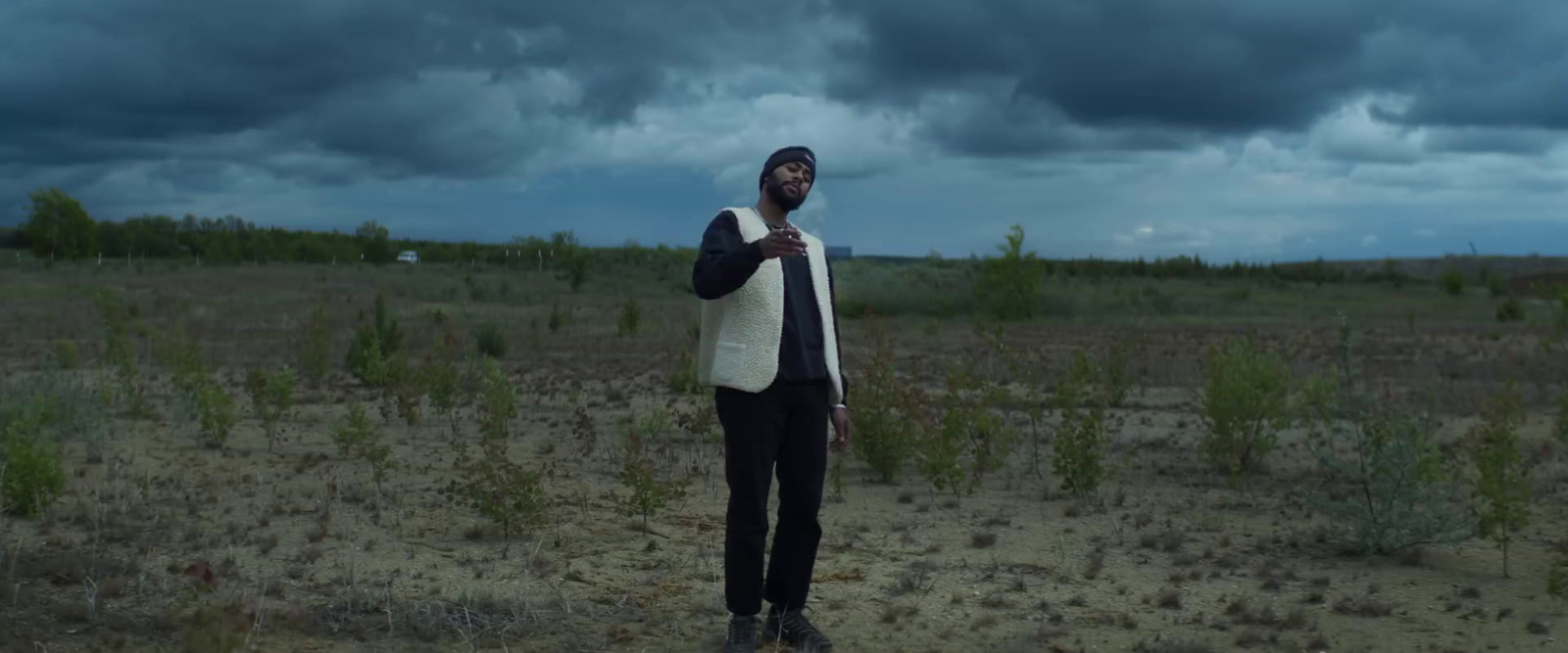 a man standing in the middle of a field