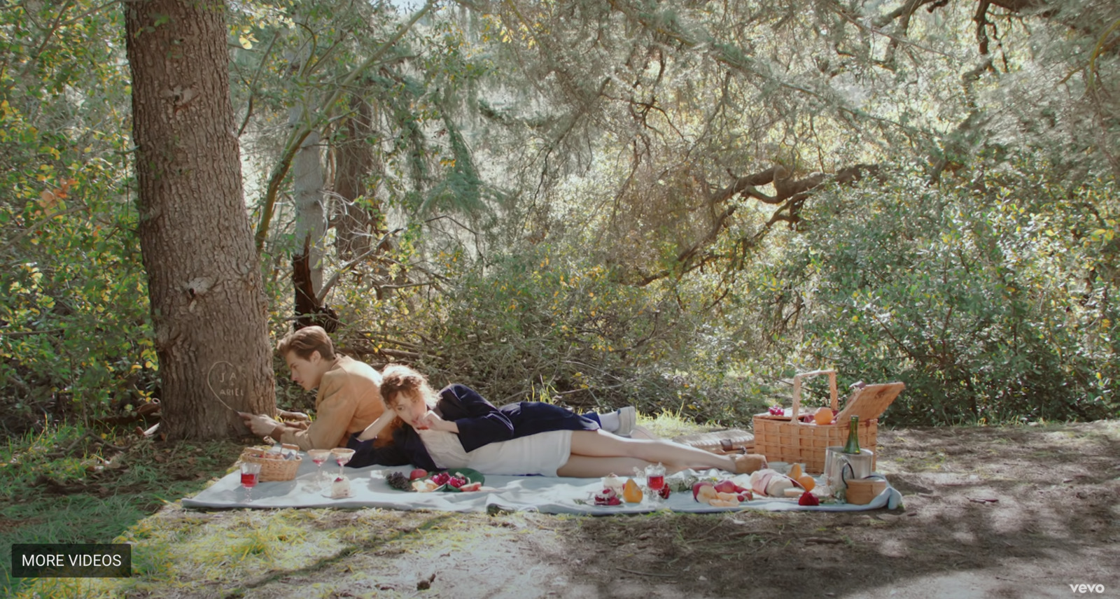 a couple of women laying on top of a blanket