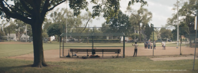 a baseball field with a bench in the middle of it