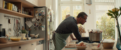 a man standing in a kitchen preparing food