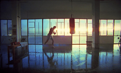 a man standing in a room with a punching bag