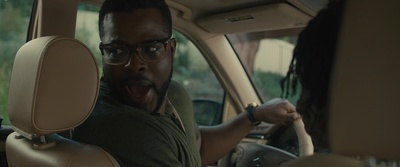 a man driving a car with a surprised look on his face