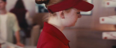 a woman with a ponytail in a red shirt