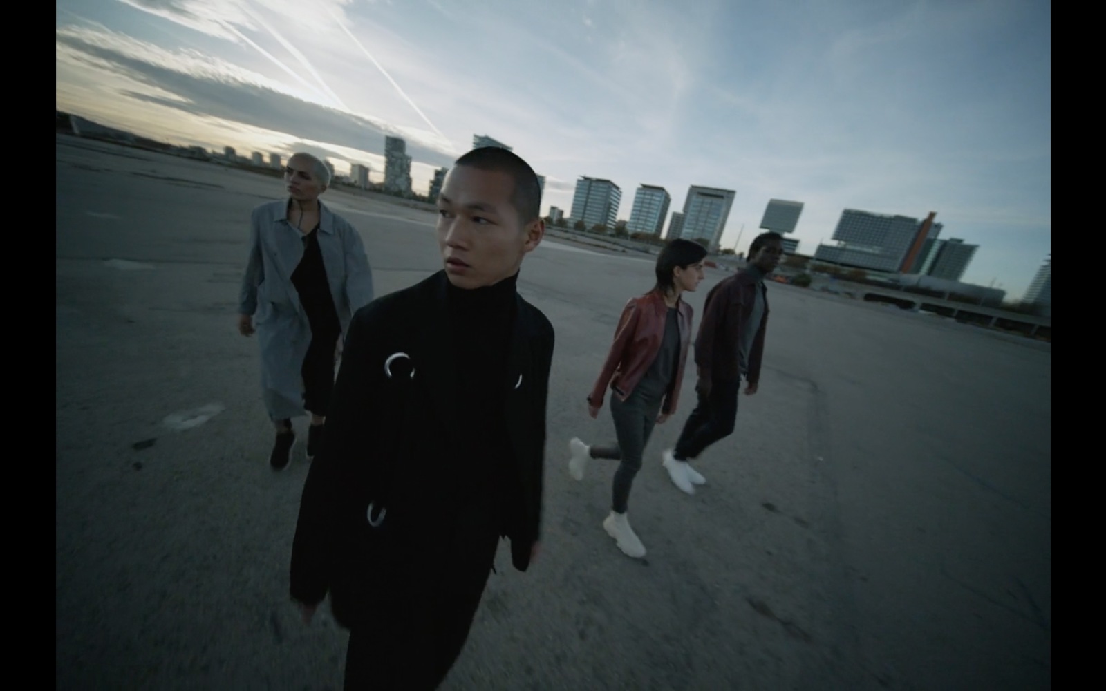 a group of young men walking across a parking lot