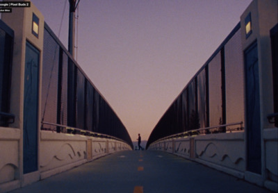 a person standing on a bridge looking at the sky