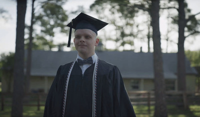 a man in a graduation cap and gown