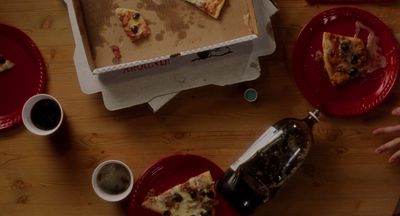 a pizza box sitting on top of a wooden table